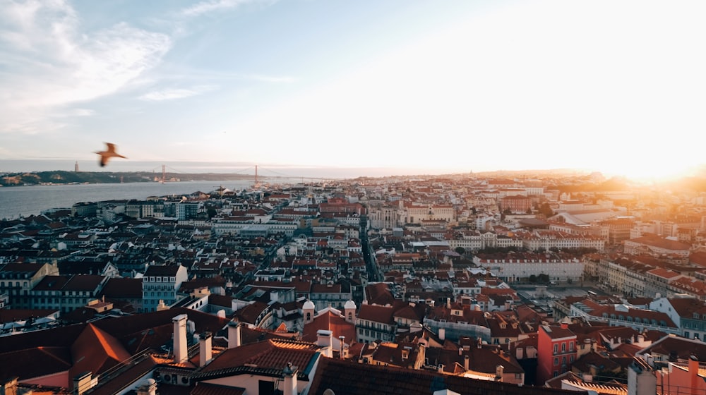 Golden-hour panorama of Lisbon's rooftops and the Tagus